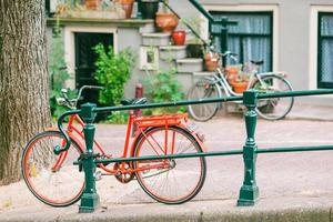 Bikes on the bridge in Amsterdam, Netherlands. Beautiful view of canals in autumn photo