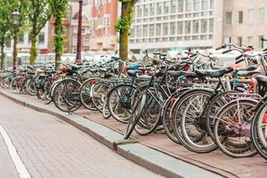 Bikes on the bridge in Amsterdam, Netherlands. Beautiful view of canals in autumn photo
