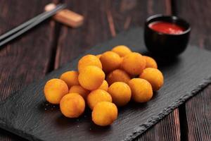 fish balls in batter with chopsticks - asian food top view photo