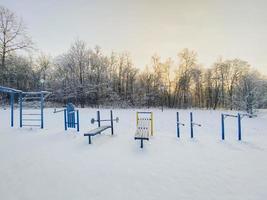 Winter sunset in snow covered park. Season and cold weather concept photo