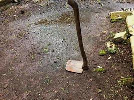 Farmer's old hoe lying on the ground photo