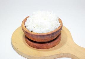 white rice in a wooden bowl on a white background photo