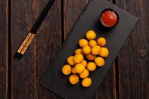 fish balls in batter with chopsticks - asian food top view photo