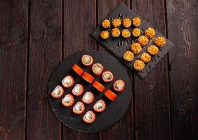 Rolls set with fish shrimp and caviar sushi with chopsticks - asian food and japanese cuisine concept photo
