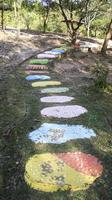 camino de piedra de paso colorido tendido en el suelo en el jardín o parque. foto