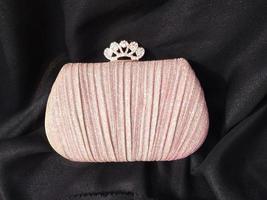 The shining pink bag looks elegant with a golden colored chain strap suitable for going to parties or invitations