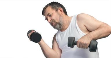 man exercising with dumbbells photo