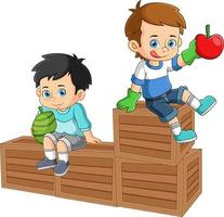 Two boys sitting on top of a fruit crate holding fresh watermelon and apple fruits vector