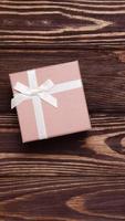 Present box on wooden background, copy space photo