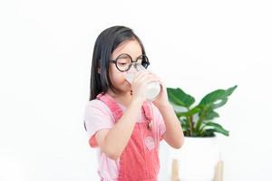 child asia girl  drink milk with a glass photo