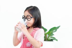 child asia girl  drink milk with a glass photo