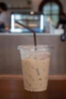 Iced coffee on wooden table photo