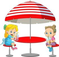 Two girls sitting in a large tent restaurant enjoying ice cream vector