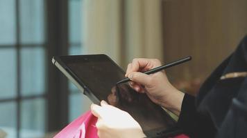 Group of businesspeople using a digital tablet together in front of office building windows overlooking the city video