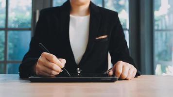 Image of two young businessmen using touchpad at meeting video