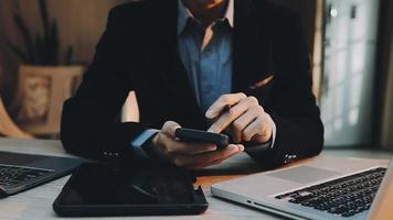 Image of two young businessmen using touchpad at meeting video