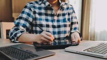 Image of two young businessmen using touchpad at meeting video