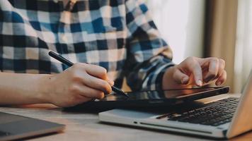 Image of two young businessmen using touchpad at meeting video