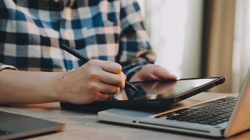 Image of two young businessmen using touchpad at meeting video