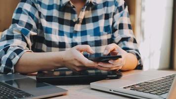 Image of two young businessmen using touchpad at meeting video