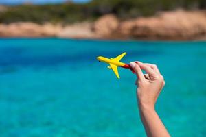 Small homemade plane on background of turquoise sea photo