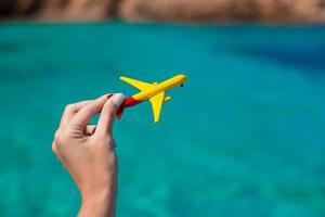 Small homemade plane on background of turquoise sea photo