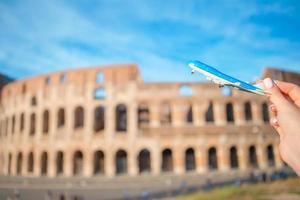 Closeup toy airplane on Colosseum background. photo