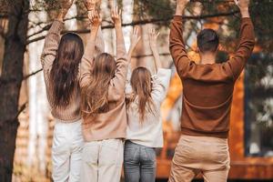 Beautiful family walking at autumn warm day photo