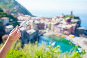 Closeup small toy model airplane background of beautiful Vernazza, Cinque Terre in Italy ,Europe photo