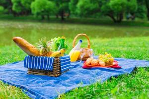 Picnic setting with white wine, pears, fruits, bread photo