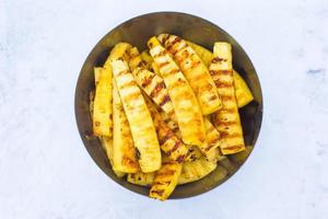 Fried pineapples on plate outdoors on snow photo