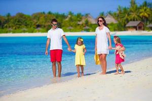 Happy beautiful family on a tropical beach holiday photo