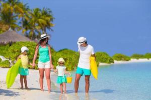 Happy family on white beach with air mattresses photo