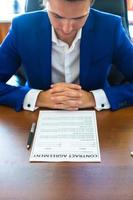 Business man signing a contract in big office photo