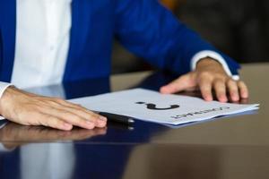 Close up of businessman thinking on a contract paper photo