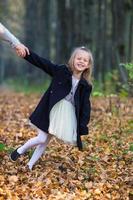 Adorable little girl outdoors at beautiful autumn day photo