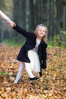 Adorable little girl outdoors at beautiful autumn day photo