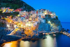 Stunning view of the beautiful and cozy village of Manarola in the Cinque Terre Reserve at sunset. Liguria region of Italy. photo