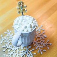 Hot chocolate with marshmallows and cute tea spoon closeup photo