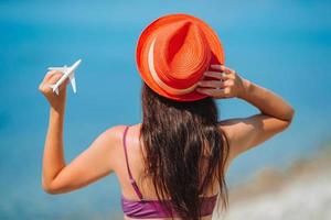 Miniature toy airplane in female hands. Trip by airplane. Conceptual image for travel and tourism. photo