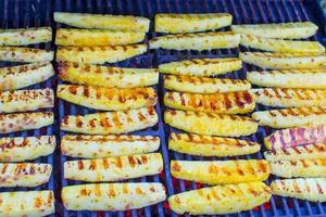 Fried pineapples on grill outdoor photo