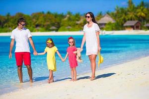 Happy beautiful family on a tropical beach vacation photo