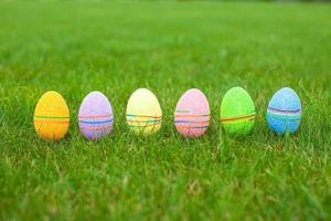 Colored colorful easter eggs in the grass photo