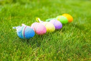 Colored colorful easter eggs in the grass photo