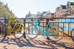 Bikes on the bridge in Amsterdam, Netherlands. Beautiful view of canals in autumn photo