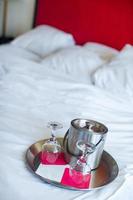 Romantic bedroom with wine glasses in luxury hotel interior photo