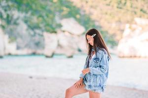 Woman laying on the beach enjoying summer holidays looking at the sea photo