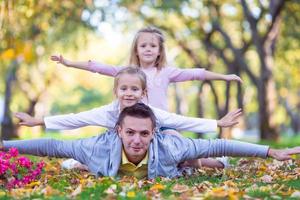 Happy family in autumn park outdoors photo