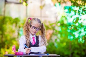 Adorable little school girl outdoor. Back to school. photo