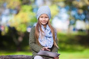 Portrait of little girl at beautiful autumn day outdoors photo